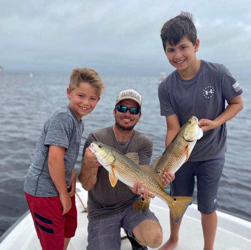 Kid friendly fishing charter. Doubled up on red fish inshore