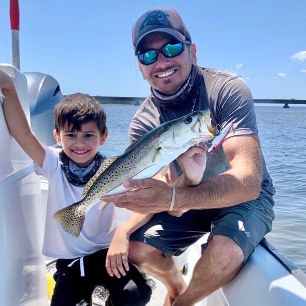 Captain Nick with his oldest son and a seatrout