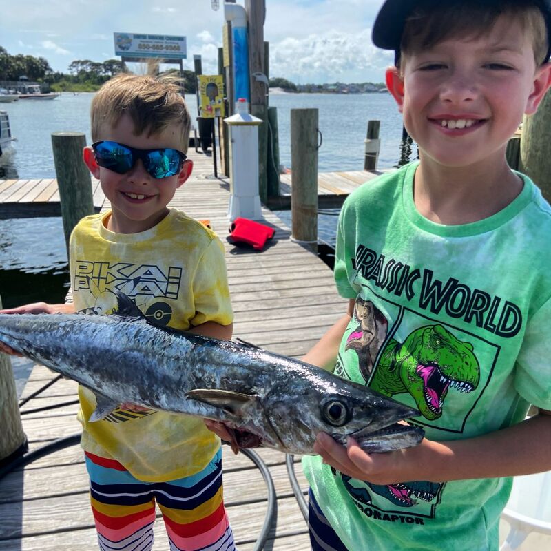 2 kids fishing for king mackerel Destin, Florida